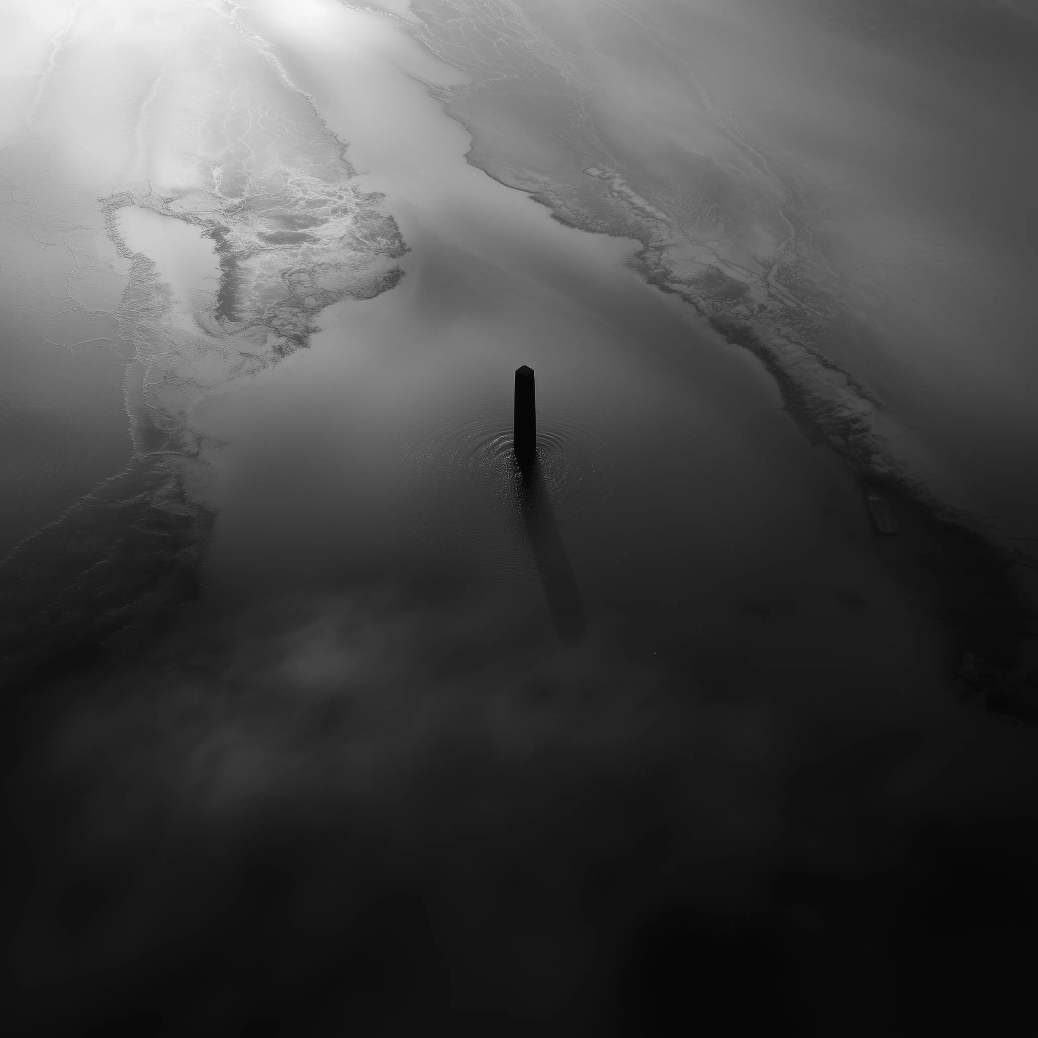 A dark, abstract monolithic form