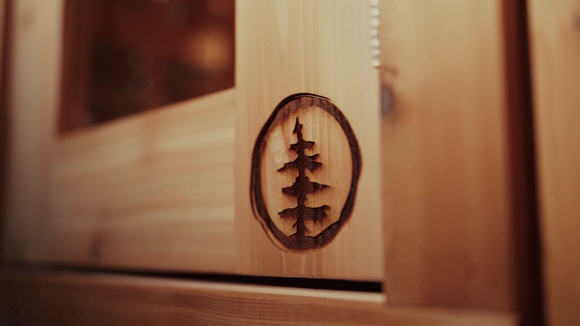 SISU tree mark branded into the wood of a sauna