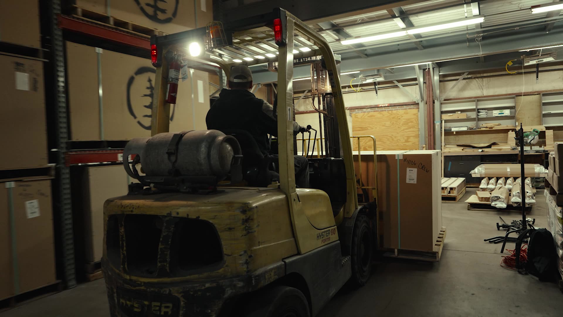 A forklift moving inventory in the SISU workshop