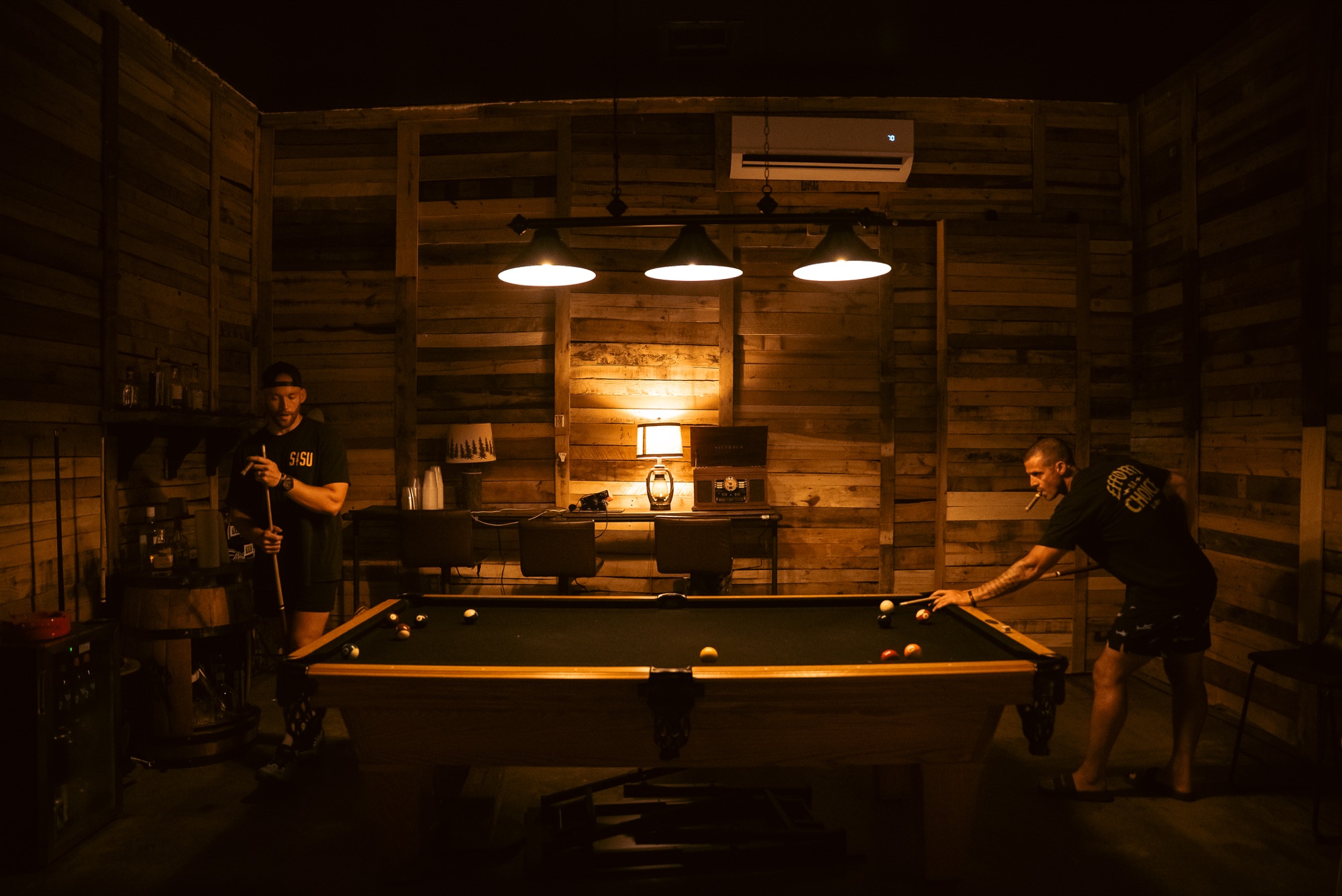 Pete Nelson II and Cory Gregory playing pool during the Muscle Island visit