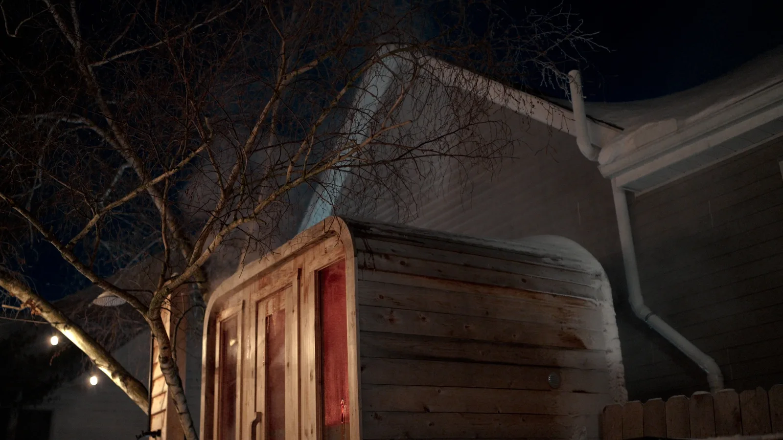 A SISU sauna steaming on a winter night
